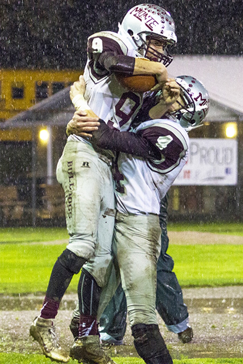 (Photo by Justin Damasiewicz)                                Montesano’s Dakoyta Reninger (right) lifts Nick Chapman in celebration after Chapman scored the winning touchdown late in the fourth quarter of an Evergreen 1A League contest against Hoquiam at Olympic Stadium.