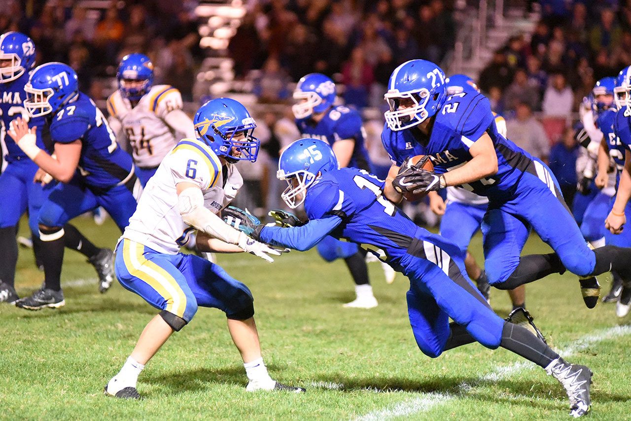 (Photo by Sue Michalak) Elma junior Tanner Krippelcz (15) blocks for senior Ira Hartford (27) during a contest against Rochester on Friday, Sept. 30.