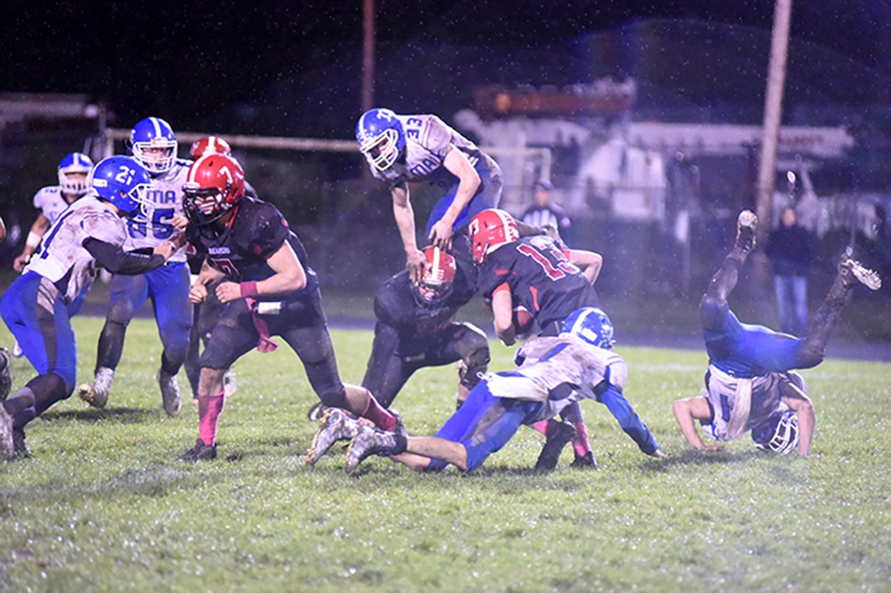 (Photo by Sue Michalak) Chaos strikes Davis Field during a contest against Tenino on Oct. 14, with Elma’s Niall Baxter (33) bounding over Tenino players.