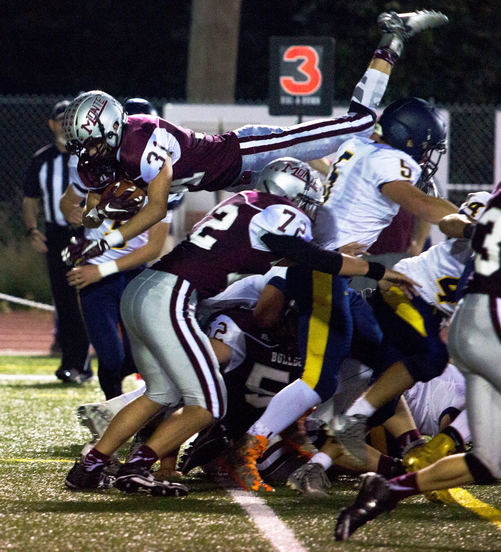 (Photo by Justin Damasiewicz)                                Montesano’s Carson Klinger leaps over a pile into the end zone during an Evergreen 1A League contest against Forks on Friday at Jack Rottle Field.