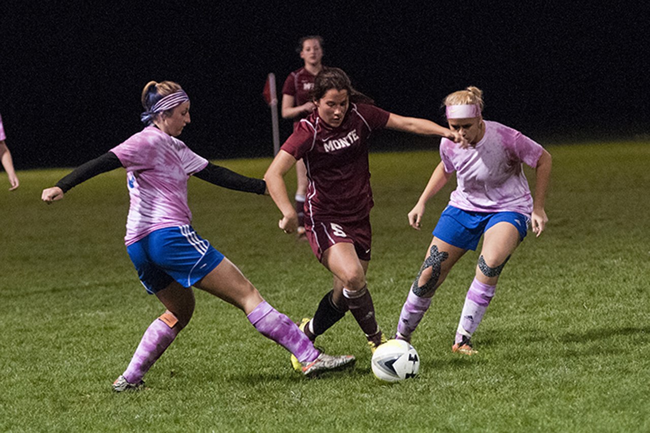 (Brendan Carl | GH Newspaper Group) Montesano’s Hannah Quinn splits Elma’s Peyton Elliott (left) and Destry Dineen on her way to the goal during an Evergreen 1A League match at Davis Field on Oct. 26.