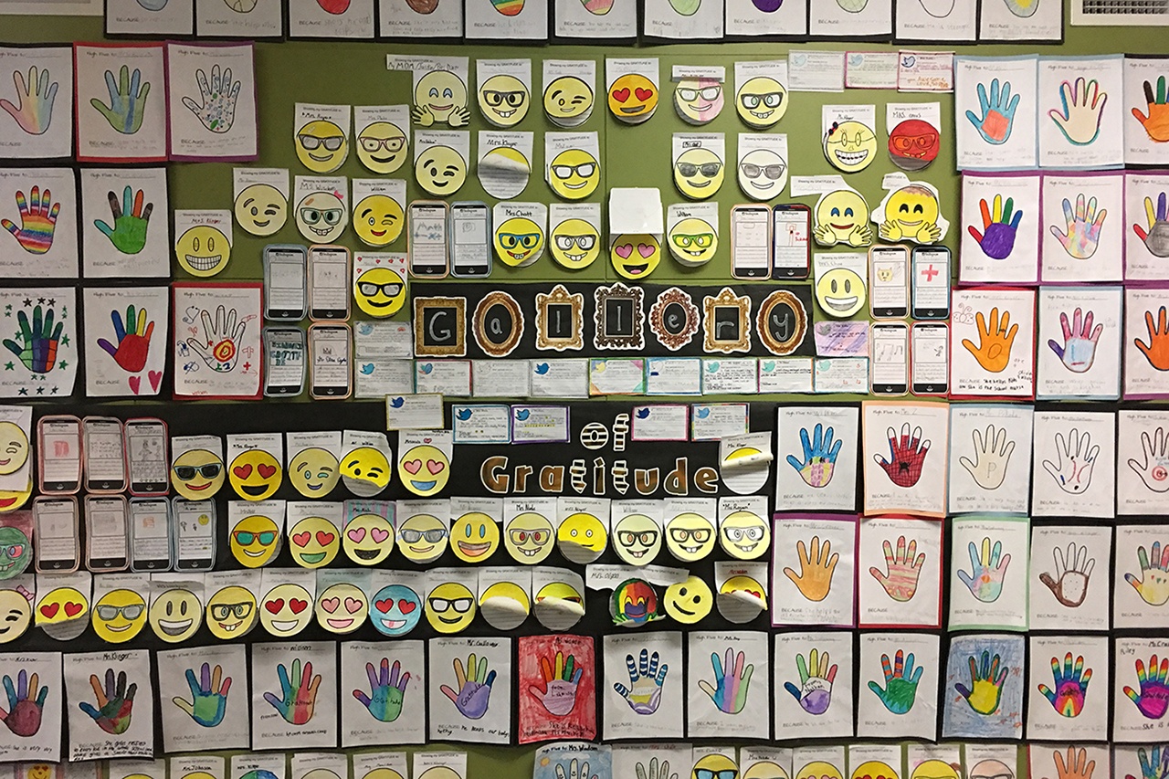 (Simpson School photo) Wall of Gratitude at Simpson School includes hands, emojis, Instagram and Twitter with a hashtag and a note to a teacher or staff member written by students.