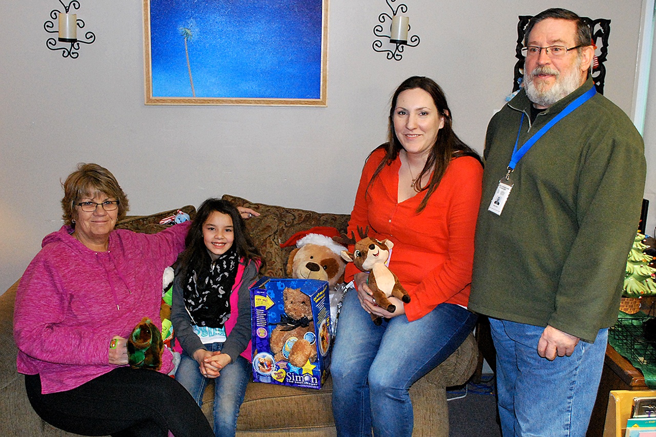 (DAN HAMMOCK|THE DAILY WORLD) Ten-year old Lilly Delahanty dropped off the teddy bears she started collecting in June at the Children’s Advocacy Center in Montesano Thursday morning. With her, from left to right, are the center’s executive director Sue Bucy, administrative assistant Nickie Till and forensic interviewer Mike Clark.