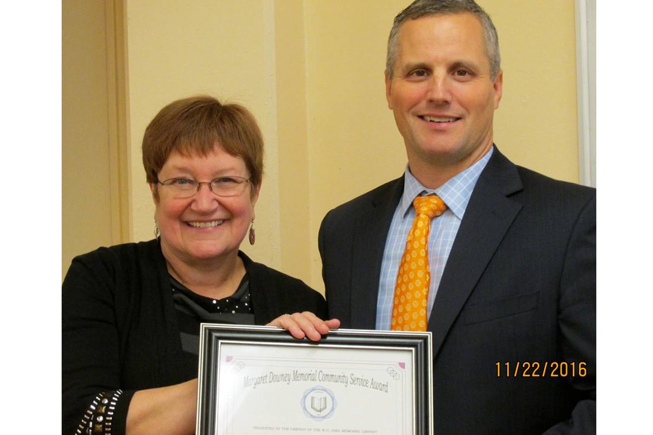 Photo by Helen Hepp Friends of the W. H. Abel Memorial Library President Cathy Carter poses with Steve Poler, the 2016 recipient of the Margaret Downey Memorial Community Service Award.