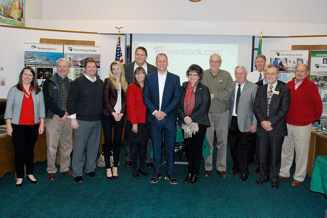 It took the efforts of more than the Port of Grays Harbor to secure a lease with online retailer Overstock.com. After the commission approved the lease, representatives of the groups involved gathered around Overstock.com Senior Vice President Carter Lee (center) for a group picture. They included Greater Grays Harbor Inc., Grays Harbor College, Pac Mountain Workforce Development Council, Grays Harbor County and the Grays Harbor PUD. DAN HAMMOCK THE DAILY WORLD