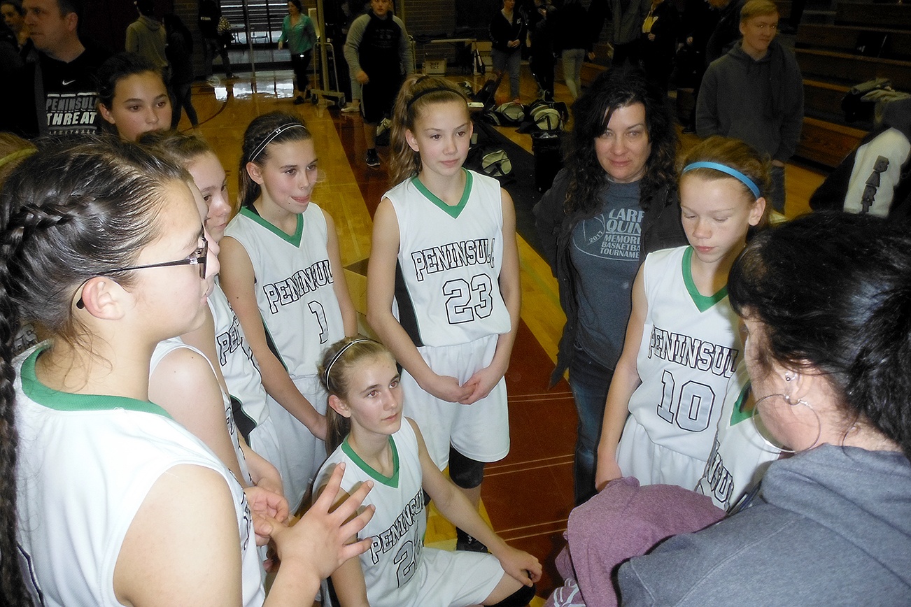 Players from the Port Angeles Threat basketball team took the top spot in the 2017 Larry Quinn Memorial Basketball Tournament, held at Bo Griffith Gymnasium in Montesano Saturday and Sunday. In the foreground handing out championship t-shirts is one of the tournament’s organizers, Roni Sue Toyra. In the back, second from the right, is Renee Quinn, Larry’s widow. Larry was a much-loved Montesano High School girls basketball team coach who died suddenly in the summer of 2013. This year’s tournament, the fourth, raised thousands of dollars for Montesano High School scholarships.