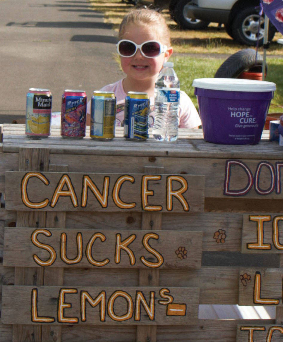 (Stephanie Morton | The Vidette) Five-year-old Nevaeh Beneze, of Elma, is ready to accept donations at her lemonade stand at the 2016 East Grays Harbor County Relay for Life. This year, the relay is a one-day event on June 2.
