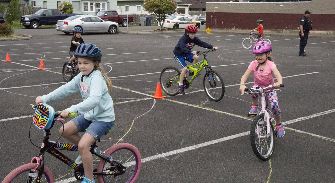 (Travis Rains | The Vidette) Bill Brookshire Memorial Bike Rodeo participants navigate through the safety course in Montesano.