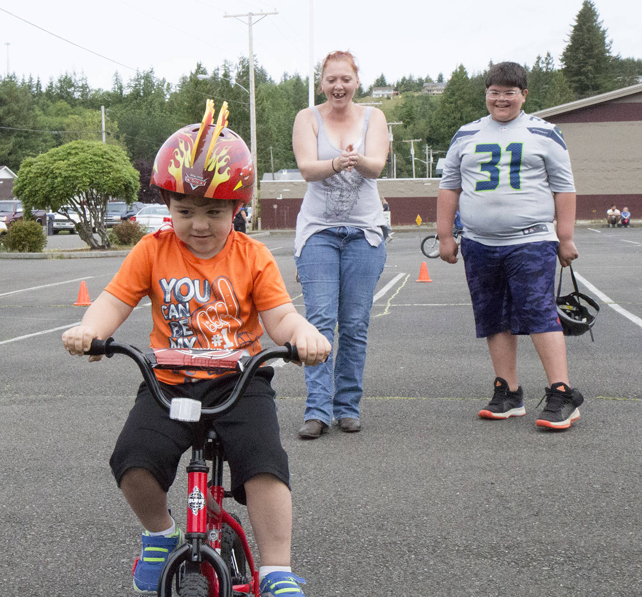 (Travis Rains | The Vidette) Eriksen Delgado, 3, of Montesano, rides his bike during the bike rodeo on June 17 in the Montesano.