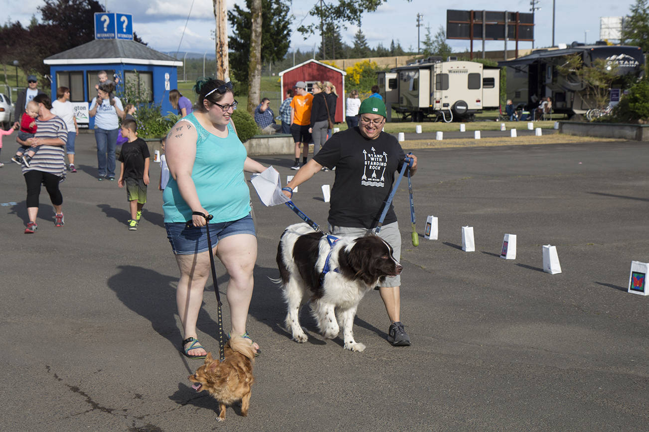 (Travis Rains | The Vidette) Tatiana Escalera (left) and Sarah Alvarez and their dogs Izzy (left) and Francis participate in Bark For Life at the East County Relay June 2.
