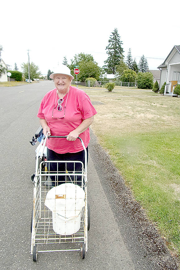 (Photo by Fred Freeman) Elma resident Dorothy Rathburn walks the streets of her town picking up trash and properly disposing of it in receptacles.