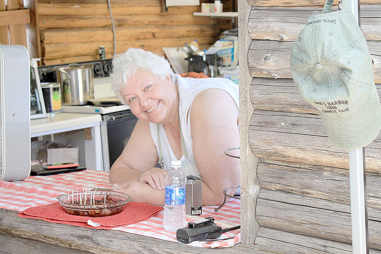 (Photo by Rod Easton) Lillie Savage mans her post at the old log cook shack at last year’s Grays Harbor County Fair in Elma.