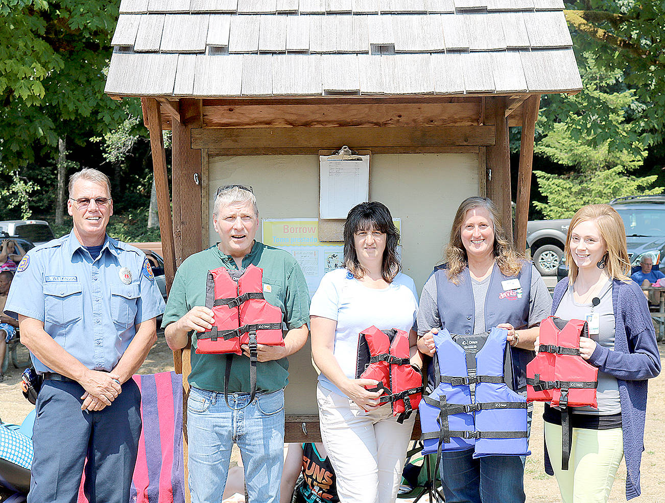 (Travis Rains | The Vidette) The Montesano Fire Department, Montesano Health and Rehabilitation Center and Dennis Company, Montesano, came together to provide new life jackets at Lake Sylvia in an effort to promote safety. From left: Lt. Rick Watkinson of the Montesano Fire Department, Duane Daniels and Amy Clark of the Montesano Health and Rehabilitation Center, Manager of Dennis Company, Montesano Janette Romine and Willow Benner of the Montesano Health and Rehabilitation Center.