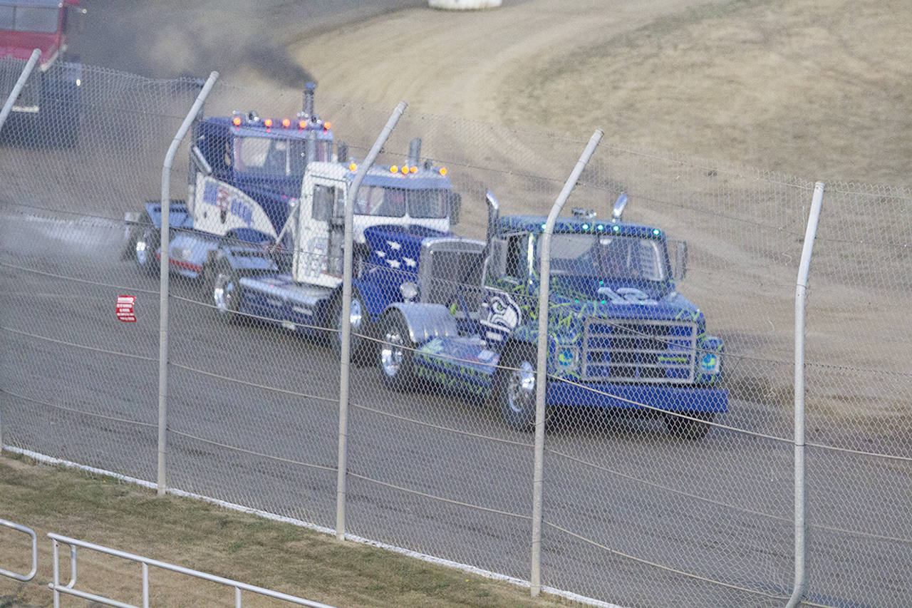 (Corey Morris | The Vidette) Mike Gibbons of Rochester is closely tailed by Dustin Smith of Renton and Scott Zahn of Rochester during a heat race for the Rolling Thunder Big Rigs at Grays Harbor Raceway on Aug. 19