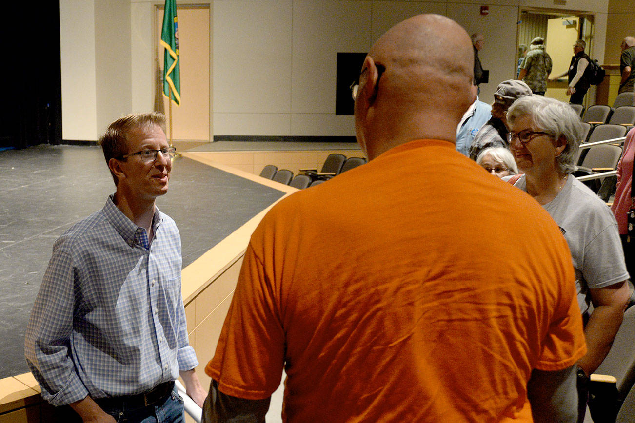 DAN HAMMOCK | THE DAILY WORLD                                Congressman Derek Kilmer chats with residents after his town hall meeting Sunday afternoon in the Aberdeen High School auditorium.
