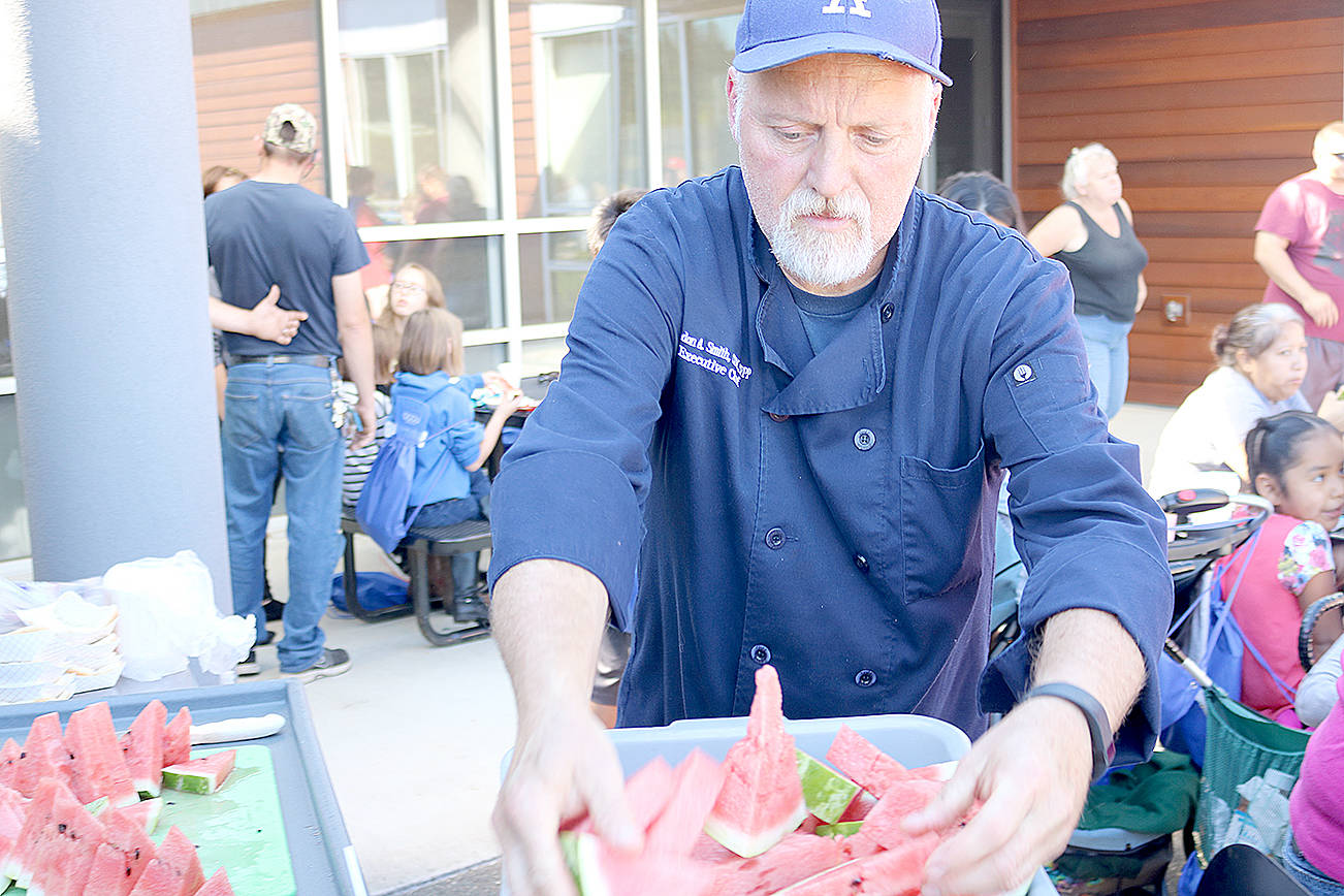 (Travis Rains | The Vidette) SPMC’s executive chef Brandon Smith and his team prepared and distributed more than 200 pounds of watermelon at Elma’s Back to School Fair at SPMC on Saturday, Aug. 22.