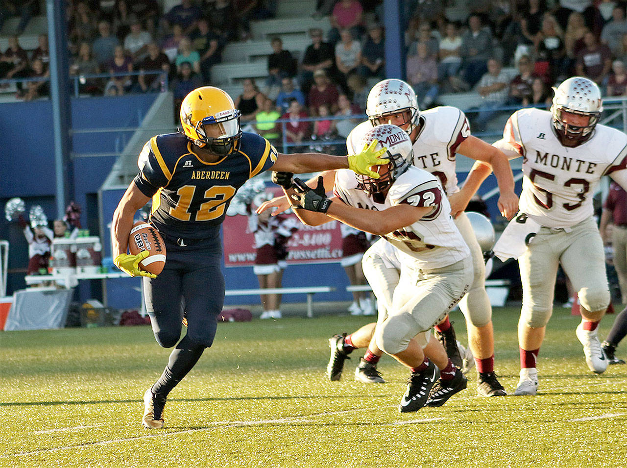 (Brendan Carl | For The Daily World) Aberdeen running back Kylan Touch straight arms a would-be Montesano tackler Friday night. Touch ran for 124 yards, caught four passes for 81 yards and a touchdown and even threw a 70-yard scoring strike to Cameron Hochstetler.