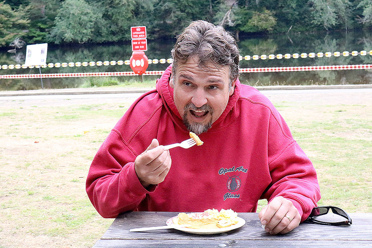(Travis Rains | The Vidette) Johnny Camp, winner of the 10K race at the Lake Sylvia Fall Festival, refuels after his victory with eggs and pancakes.