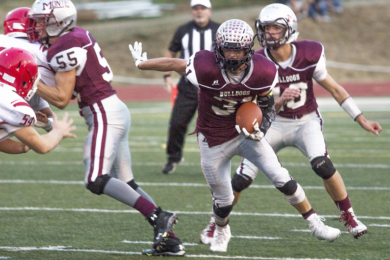 (Photo by Justin Damasiewicz) Montesano’s Carson Klinger runs through a hole at the line of scrimmage during a non-league football game against Castle Rock on Friday at Rottle Field.