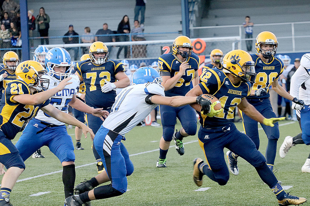 (Travis Rains | Grays Harbor Newspaper Group) Kylan Touch avoids and breaks tackles as he makes his way to the end zone for the first touchdown of Friday night’s game.