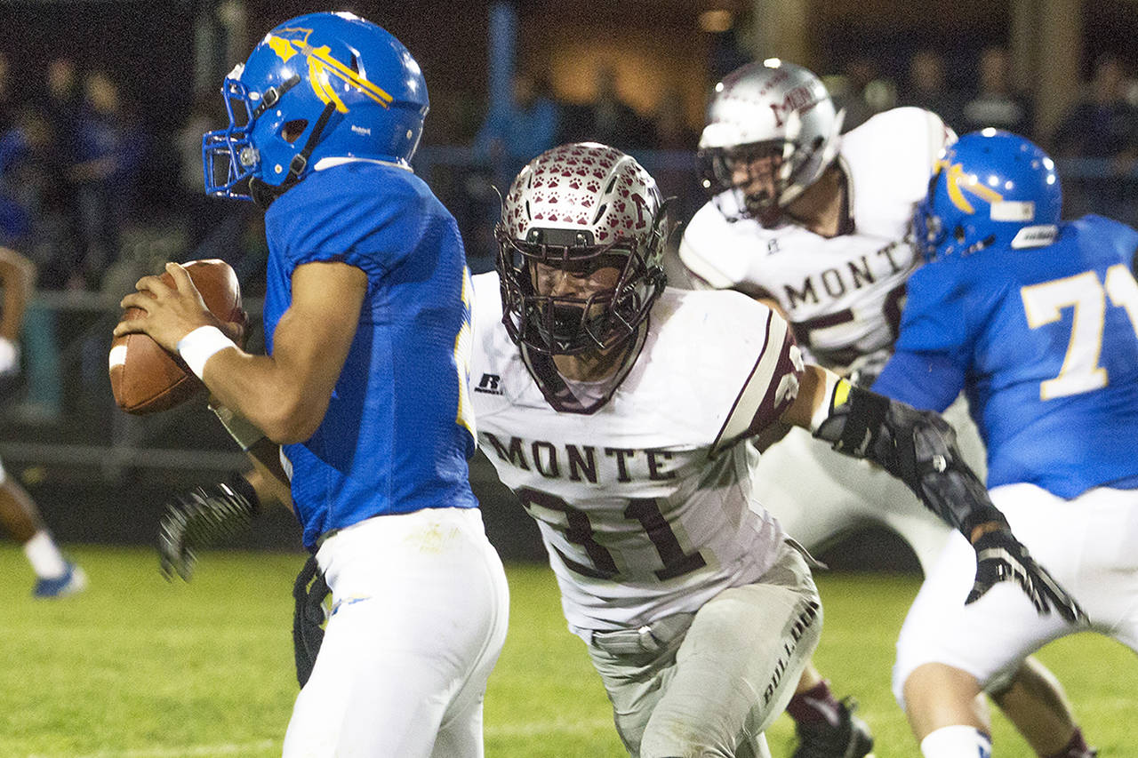 (Photo by Justin Damasiewicz) Montesano’s Carson Klinger closes in on Rochester Quarterback Bryce Lollar during a non-league game on Friday at Rochester High School.