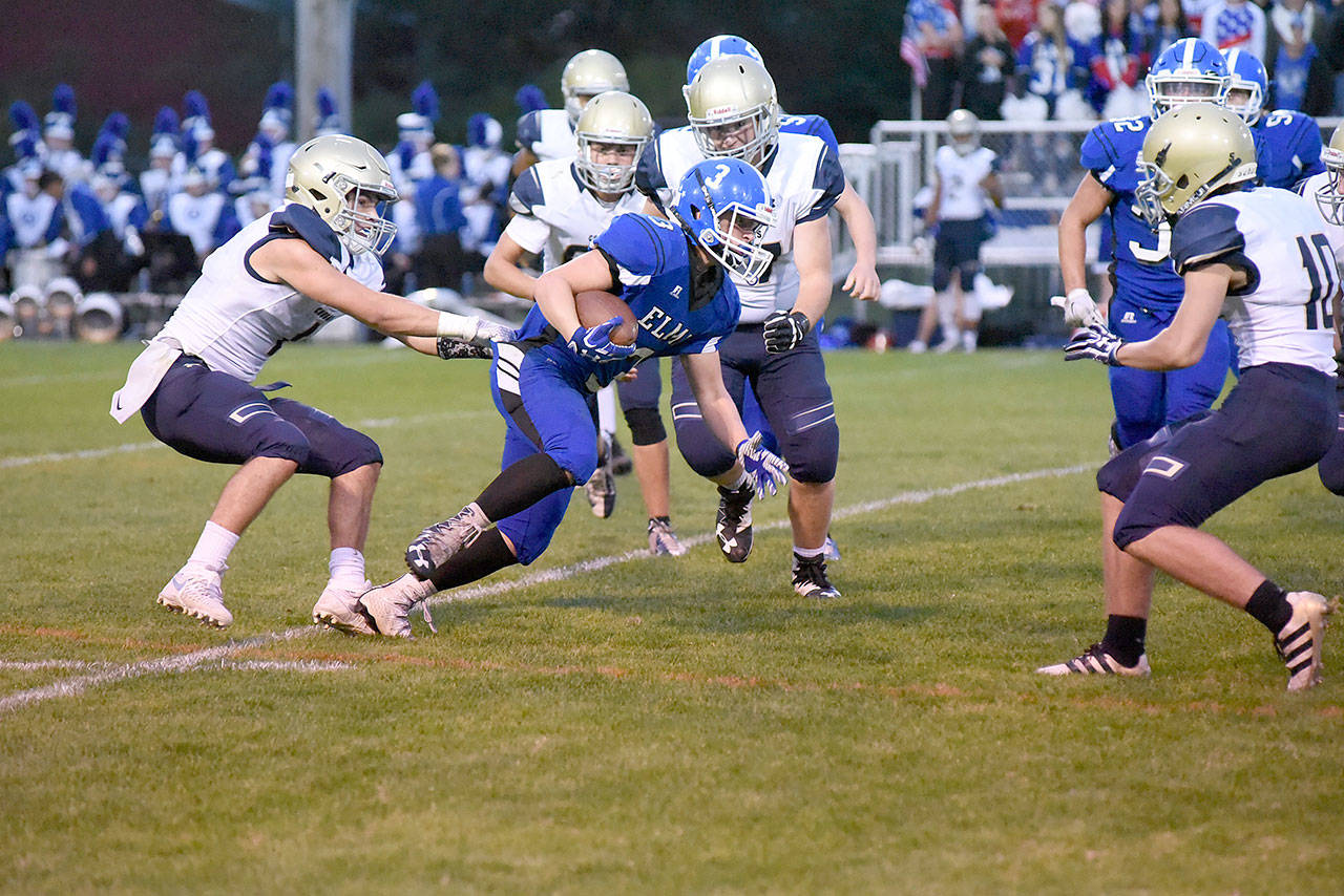 (Photo by Sue Michalak)                                Elma running back Brady Shriver tries to break a waistband tackle on Friday night at Davis Field in Elma. Shriver carried the ball 11 times for 112 yards but the Eagles lost, 36-28.
