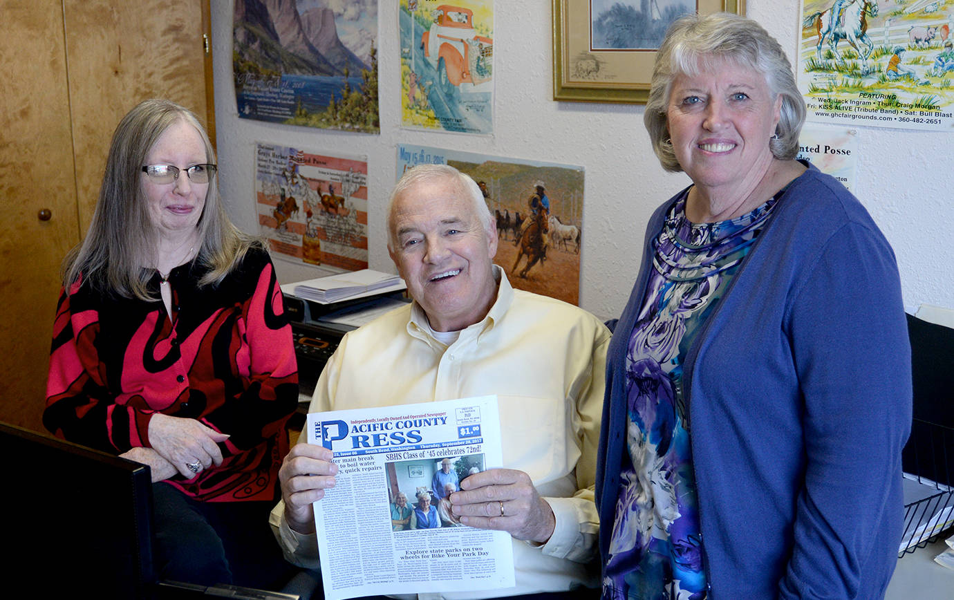 DAN HAMMOCK | THE DAILY WORLD                                Daily World publisher Stan Woody is flanked by Loretta Hodgson (right) and Chris Petrich, who founded the Pacific County Press weekly newspaper in South Bend more than 20 years ago. On Thursday, Sound Publishing, owners of the Daily World, announced the company had purchased the Pacific County Press.