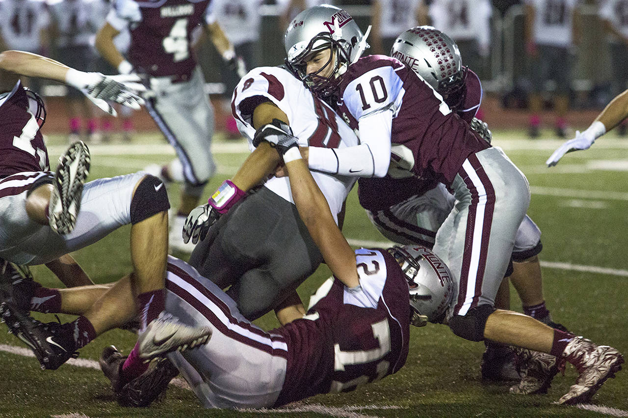 (Photo by Justin Damasiewicz) Montesano’s Trevor Ridgway (10) and Jared Wallace (72) team up to tackle Hoquiam’s Asai Villarreal during an Evergreen 1A League game on Oct. 13 at Rottle Field.