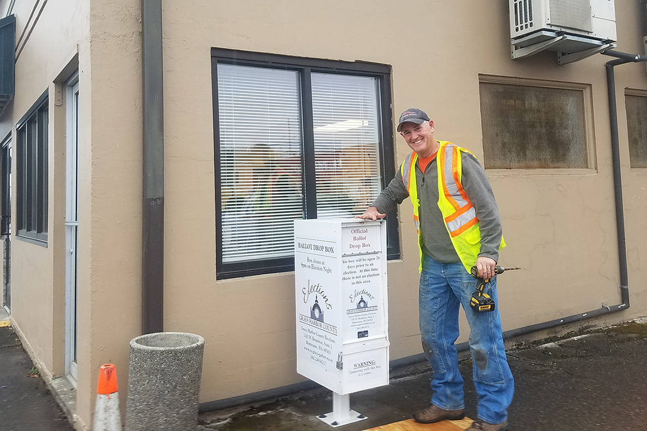 (Photo by Jim Sorensen) Mike Adams poses beside the new Elma ballot drop box. The box was installed the day ballots were mailed to voters.