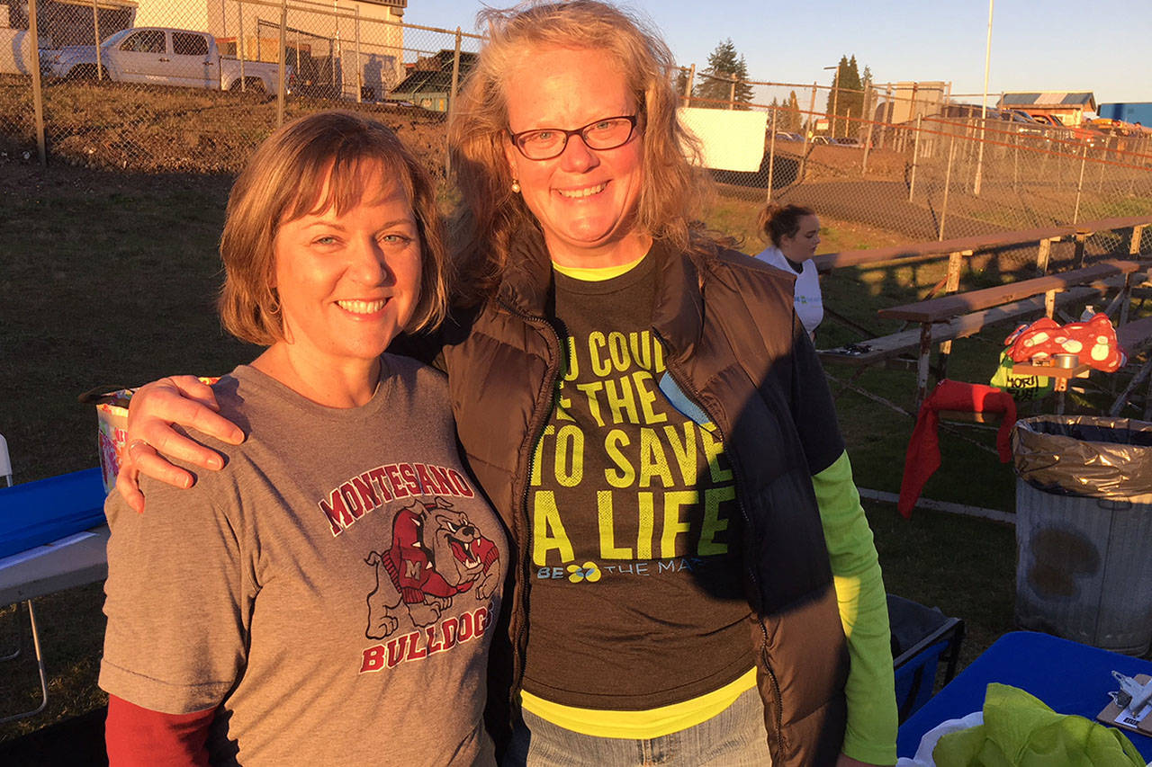 Todd Bennington | The Vidette                                Montesano teacher Lori Bialkowsky, left, poses with Be The Match rep Tori Fairhurst before the Elma-Montesano football game on Oct. 27. The pair organized a bone marrow donor registry drive in honor of Montesano counselor Tami Herzog who is suffering from a form of blood cancer.