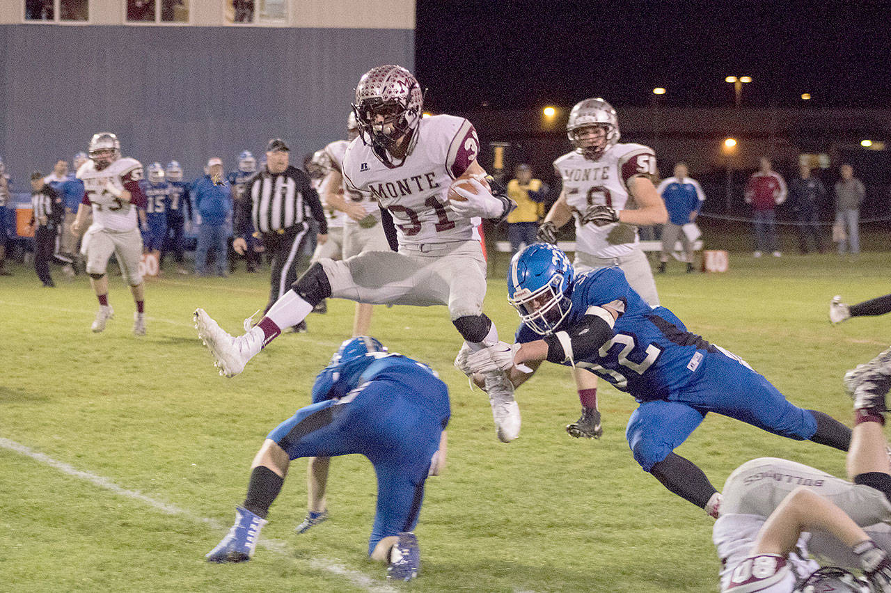 Montesano running back Carson Klinger hurdles an Elma defender during a 47-yard run on Friday night at Davis Field in Elma. The Bulldogs won the game, 51-0. (Brendan Carl Photography)