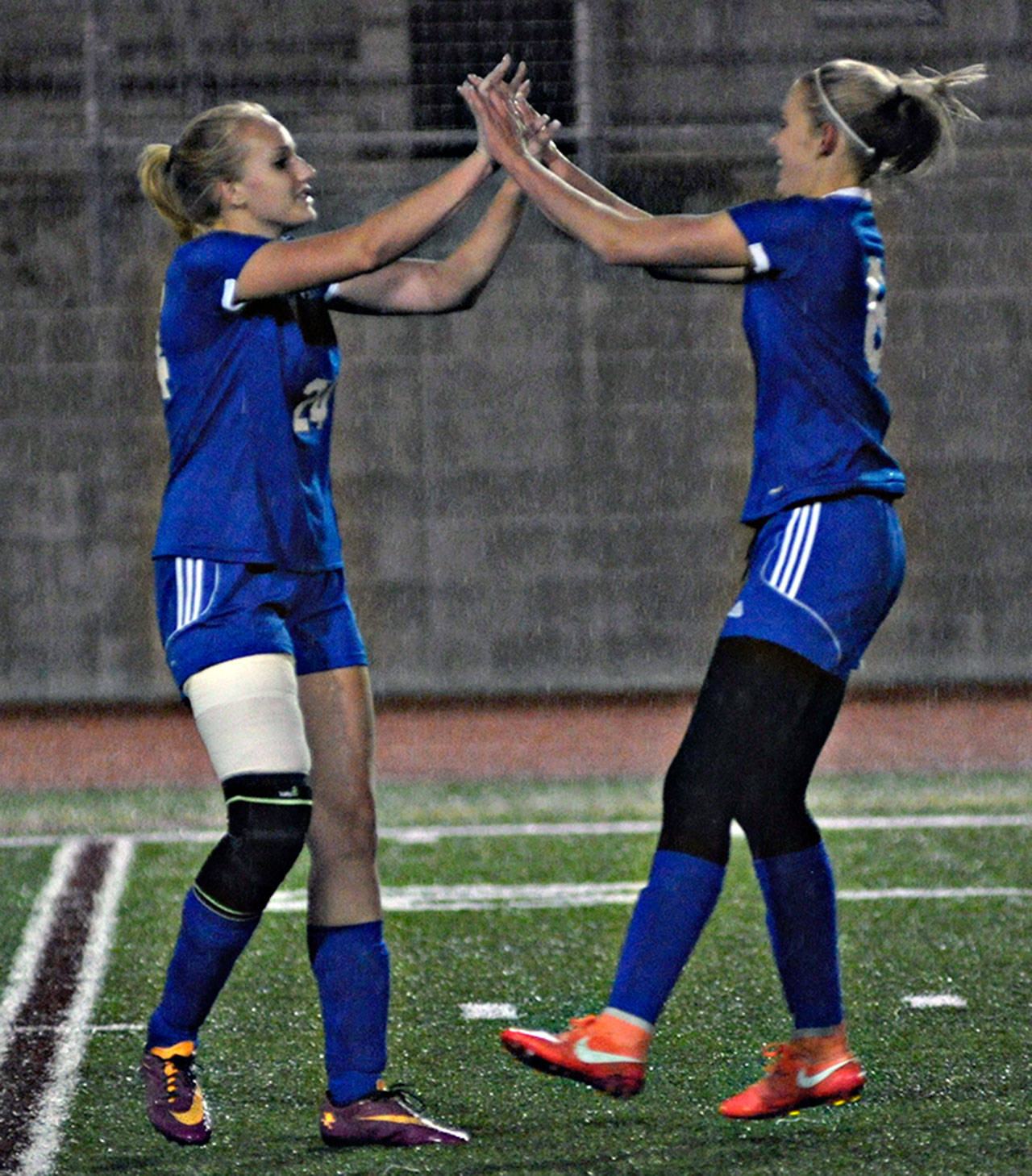 Brooke Sutherby (right) is congratulated by Molly Johnson after scoring Elma’s only goal against King’s Way on Thursday. Elma lost 5-1 t the Eagles.