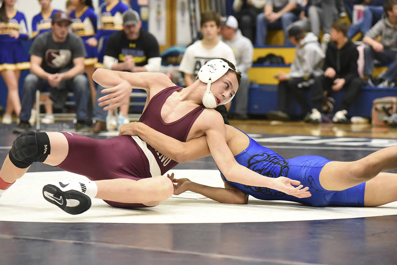 Photo by Sue Michalak                                Ty Ekerson of Montesano with a first round reversal against Miguel Jesus-Miguel of North Mason.