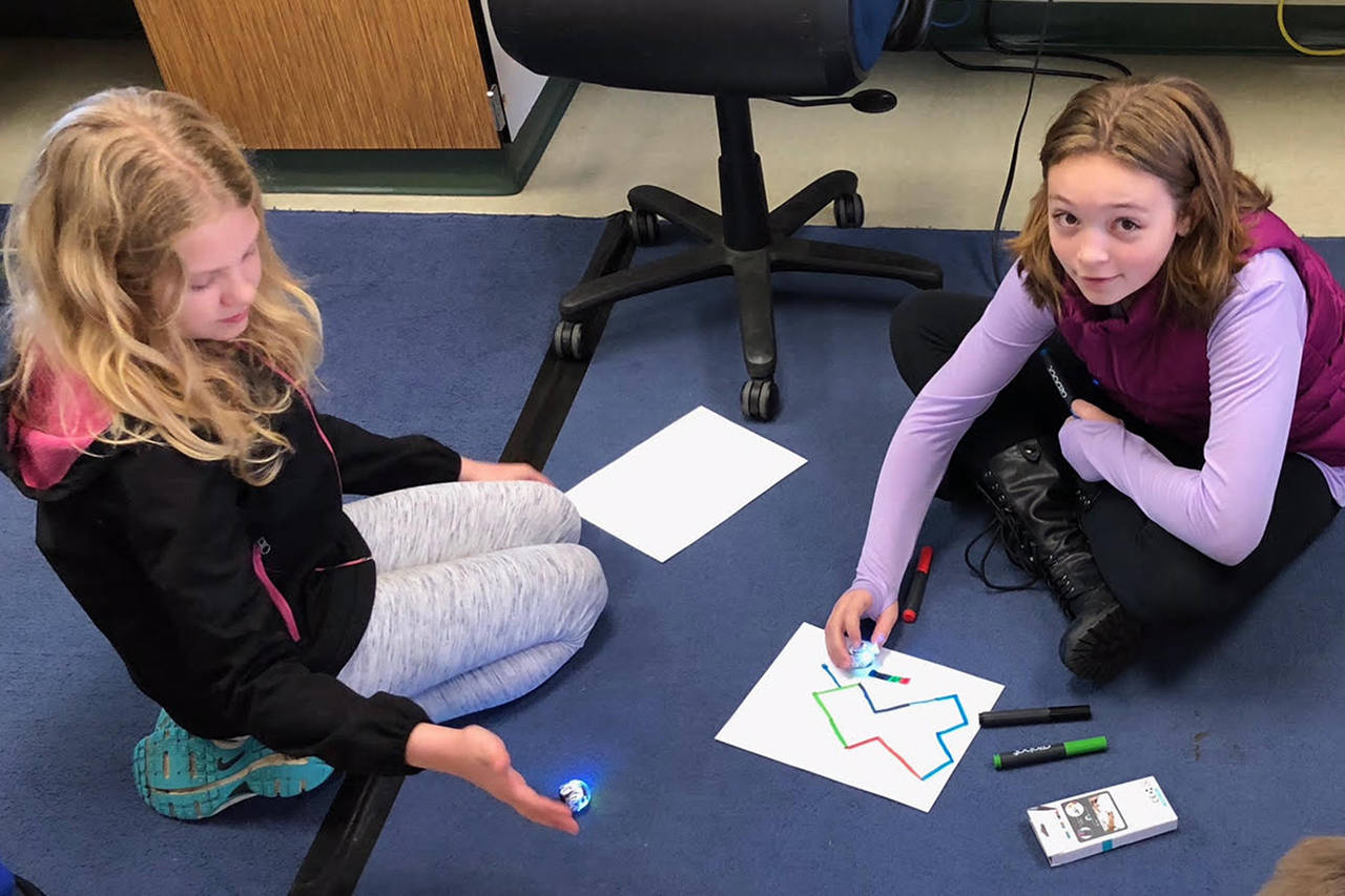 (photo provided by McCleary School District)                                McCleary students Taryn Ferrier and Tatum Sanders work on coding Ozobots, which are pocket-sized programable robots.