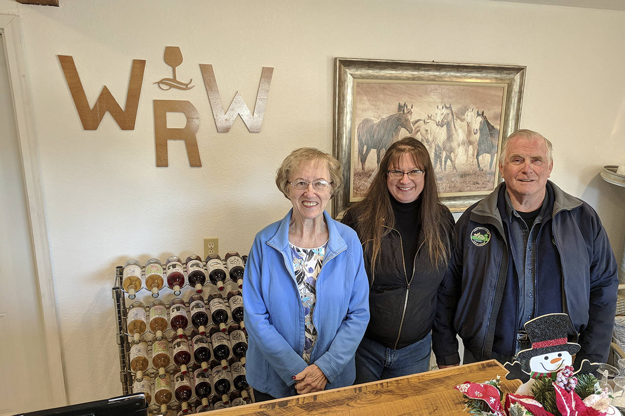 (Corey Morris | The Vidette)                                Denise Schupbach, at center, has opened a winery up the Wynoochee Valley featuring several varieties of berry wines. Family, including Kay Comin, left, and Tom Skinner, right, help the process along.