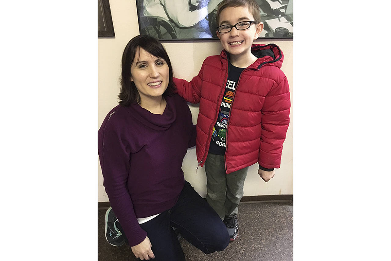 (Todd Bennington | The Vidette) Tess Lawson with son Seth, 6, during a visit to The Videttes offices last week. Seth has gained local notoriety for having quickly developed his piano skills after only a few months of playing.