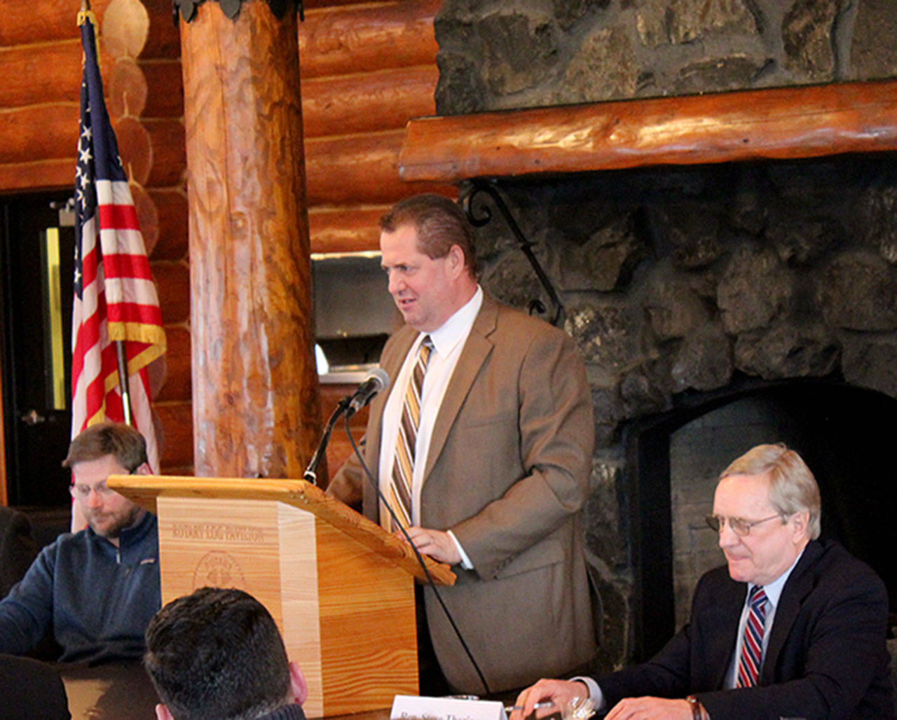 Rep. Brian Blake takes the podium, with Rep. Steve Tharinger, right, and Rep. Mike Chapman, left, at the Aberdeen Rotary Log Pavilion for the annual Legislative Sendoff sponsored by Greater Grays Harbor Inc.
