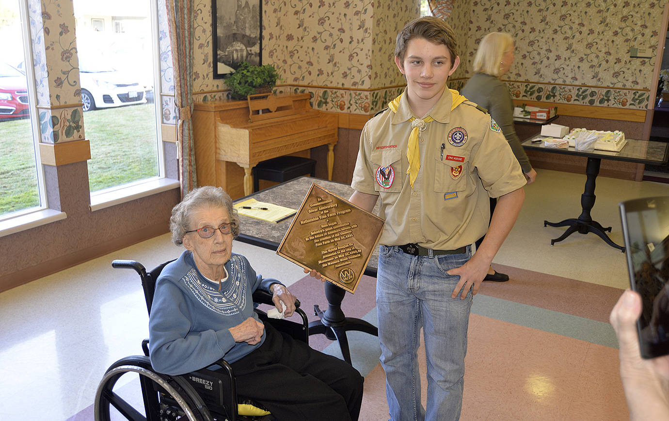 DAN HAMMOCK | TWIN HARBORS NEWSPAPER GROUP                                Pat Clemons, East County historian and former school teacher from Montesano, is presented with a new plaque honoring the tree farm centennial Sunday. Eric Koecke made the plaque as part of his Eagle Scout project and replaces the original plaque which was damaged. The Sunday event was honoring the renaming of the Chehalis Valley Historical Museum the Pat Clemons Chehalis Valley Historical Museum.