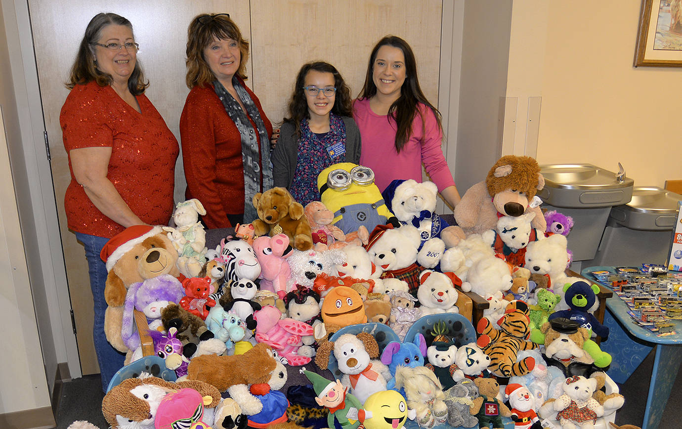 DAN HAMMOCK | THE DAILY WORLD                                Lilly Delahanty, the official Teddy Bear Officer for the Montesano VFW Auxiliary, shows off the stuffed toys she collected all year before donating them to the Children’s Administration Office in Aberdeen Friday. Pictured from left are VFW Auxiliary President T.J. Glick, Auxiliary Secretary Diane Nillson, Lilly and her mom, Ciara Brough.