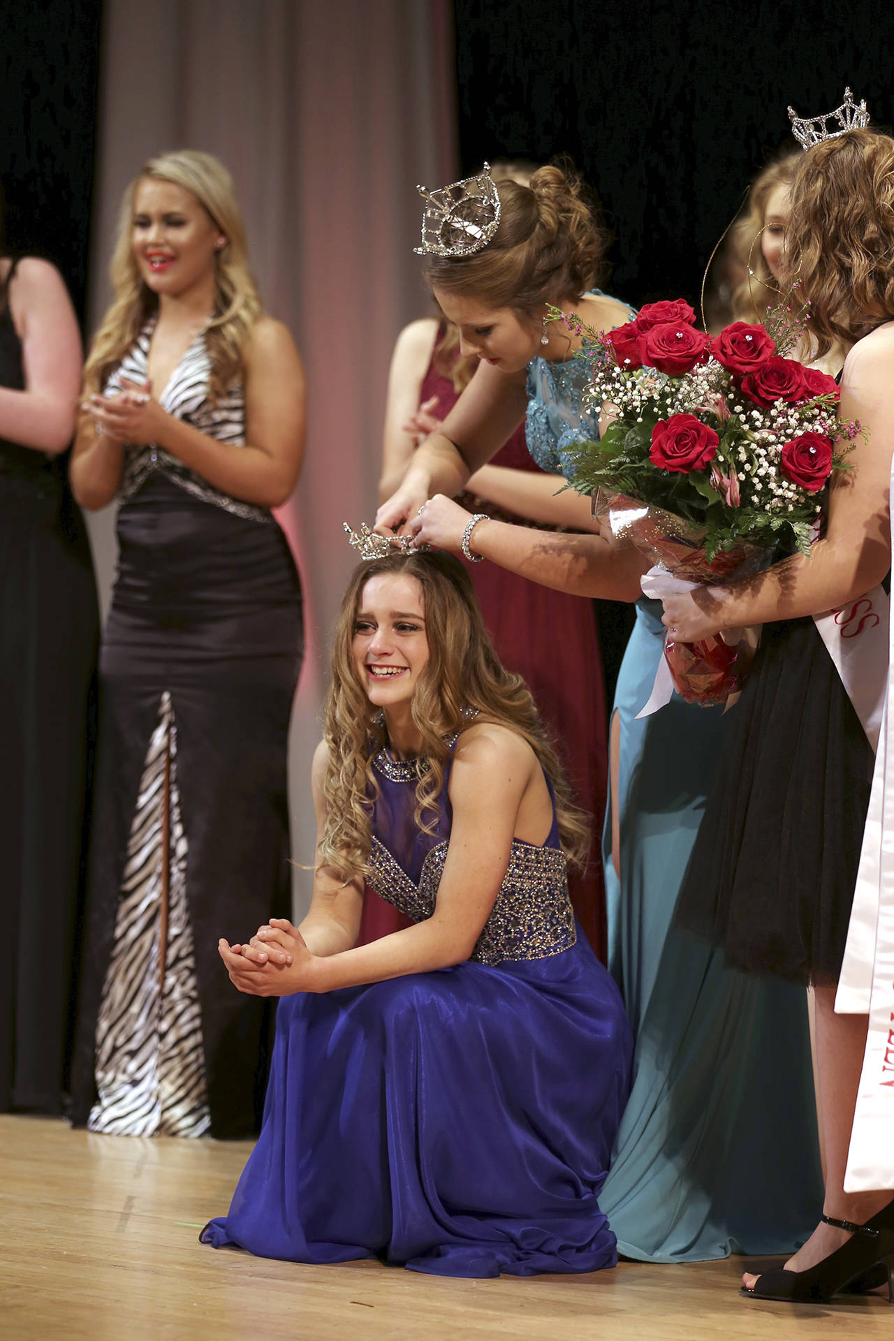 Photo by Keith J. Krueger                                2017 Outstanding Teen Paicyn Dragoo places the crown on 2018 winner Mercedes Morrill at the annual pageant.