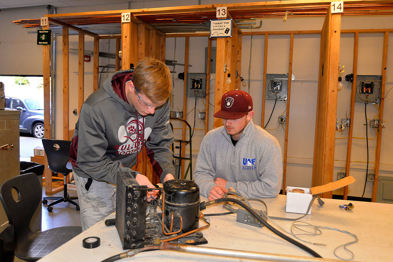 LOUIS KRAUSS | THE DAILY WORLD Gage Iverson and Matthew Plato, both seniors from Montesano High School, work on a fish tank cooler during electrical engineering class at Aberdeen High School. They drive to Aberdeen in the afternoons for the class.