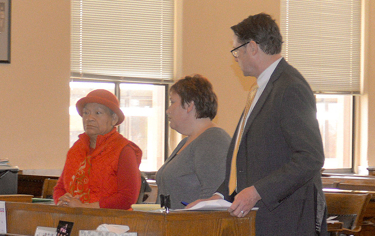DAN HAMMOCK | THE DAILY WORLD                                Gloria Gilroy (left) and her daughter Davina made their first court appearance Monday after being charged with first degree theft earlier this year. Deputy Prosecutor Richard Peterson is at right.