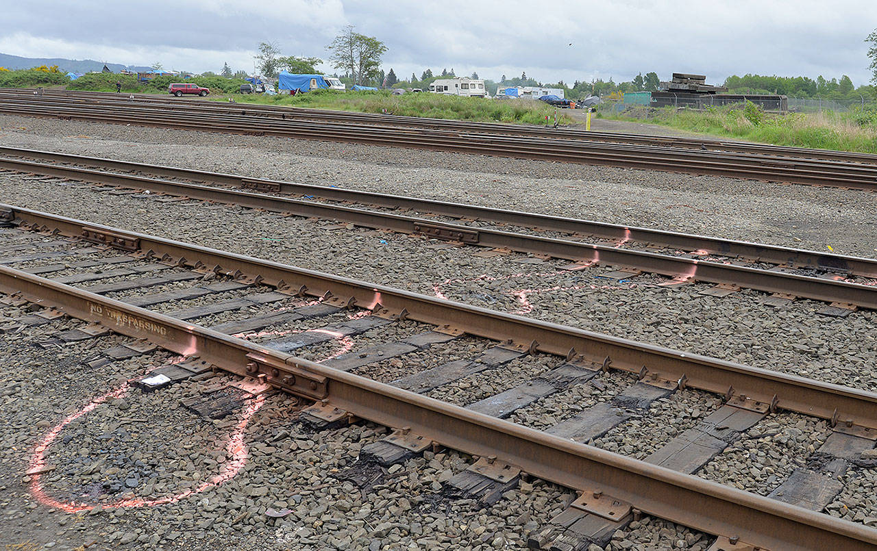 DAN HAMMOCK | THE DAILY WORLD                                Bright spray paint surrounds the area where a 48-year-old woman had both legs severed when she was struck by a train early Thursday morning. The photo was taken at the track closest to the end of South Michigan Street just south of Harbor Battery and State Street, facing south and east toward the Chehalis River.