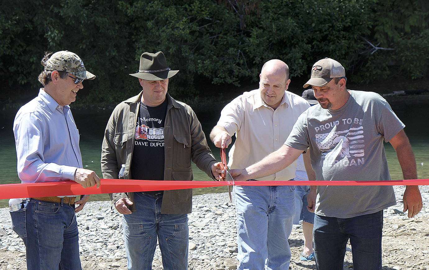 DAN HAMMOCK | TWIN HARBORS NEWSPAPER GROUP                                Representatives from the legislature, Green Diamond Resource Company and the Department of Fish and Wildlife cut the ribbon at the reopened Wynooche River boat launch Friday afternoon. Second from right is new Fish and Wildlife director Kelly Susewind, who officially takes office Aug. 1.