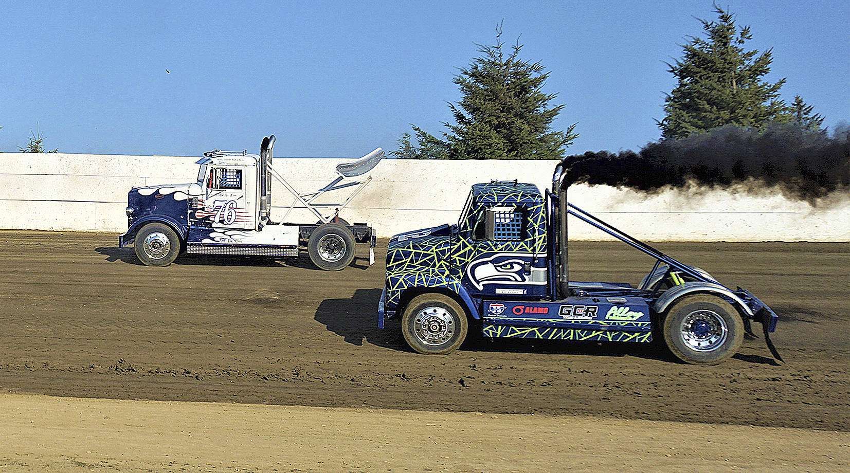 Photo by AR Racing Videos Leo Norris (76) and Jerome Burdick race around the Grays Harbor Raceway track in preparation for the Rolling Thunder Big Rigs race on Saturday in Elma.