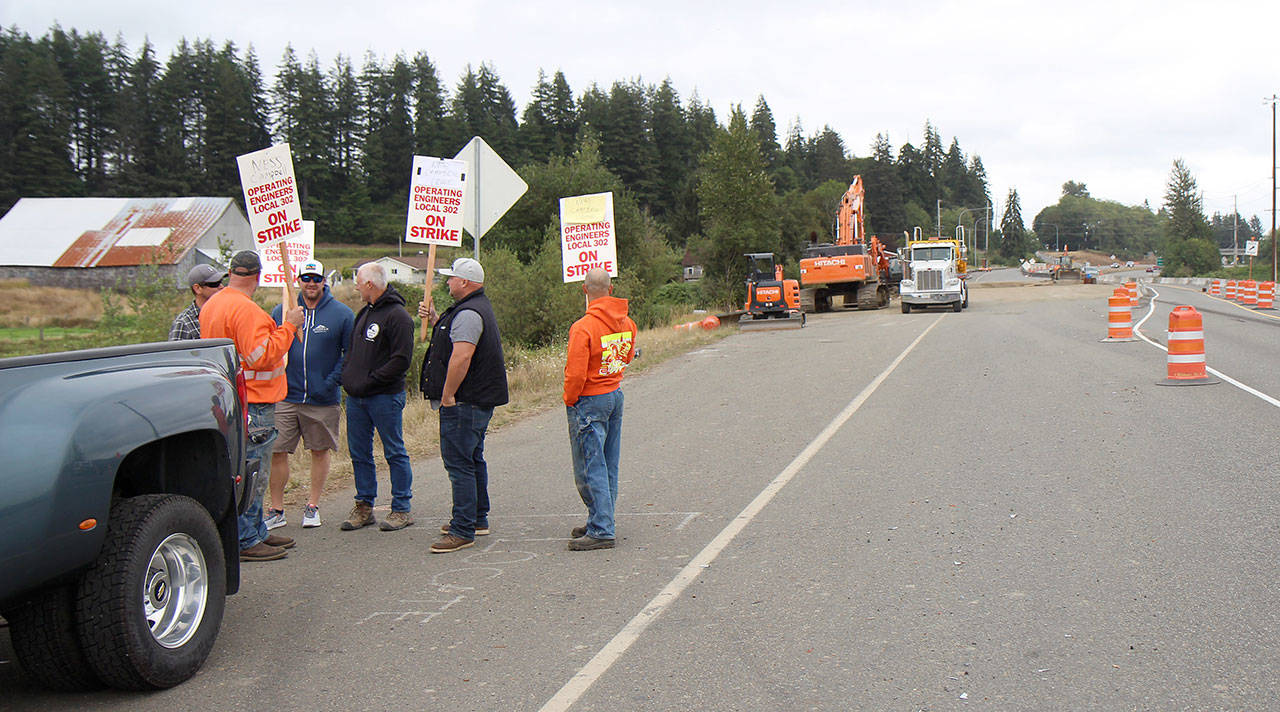 Six men, who did not wish to speak with reporters, set a picket line Thursday, Aug. 23, 2018, at the state Department of Transportation U.S. Highway 12 worksite west of Montesano. Photo by Michael Lang, The Vidette.