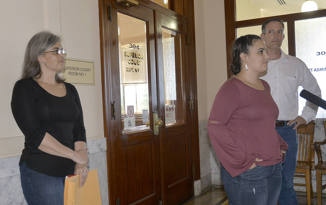 Dan Hammock | Twin Harbor Newspapers                                AnnMarie Shuck is flanked by her mother, Holly, and dad, Travis, as she faces the media after Superior Court Judge Ray Kahler amended his ruling of AnnMarie’s accused abductor to guilty of second-degree attempted kidnapping.