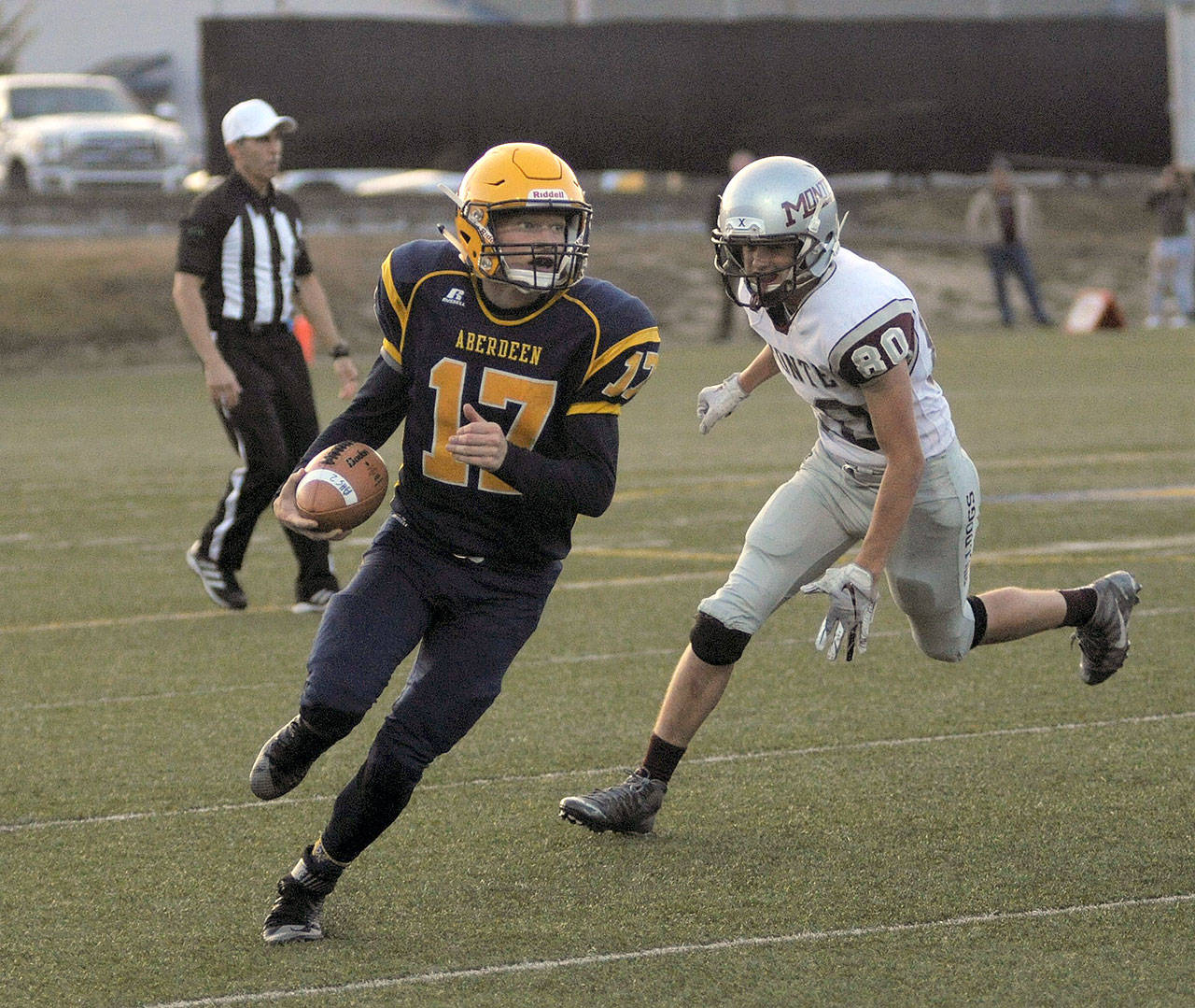 Aberdeen’s Ben Dublanko, left, rolls out of the pocket before scrambling down the sidelines against Montesano on Friday Sept, 7. (Hasani Grayson | The Daily World)