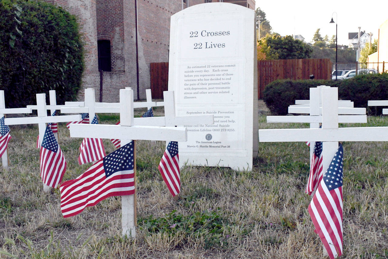 Jeannie McMacken | Peninsula Daily News                                The American Legion Post No. 26 in Port Townsend has a display of 22 American flags and simple white crosses meant to remind viewers that 22 veterans commit suicide every day in the United States. September is National Suicide Prevention Month.
