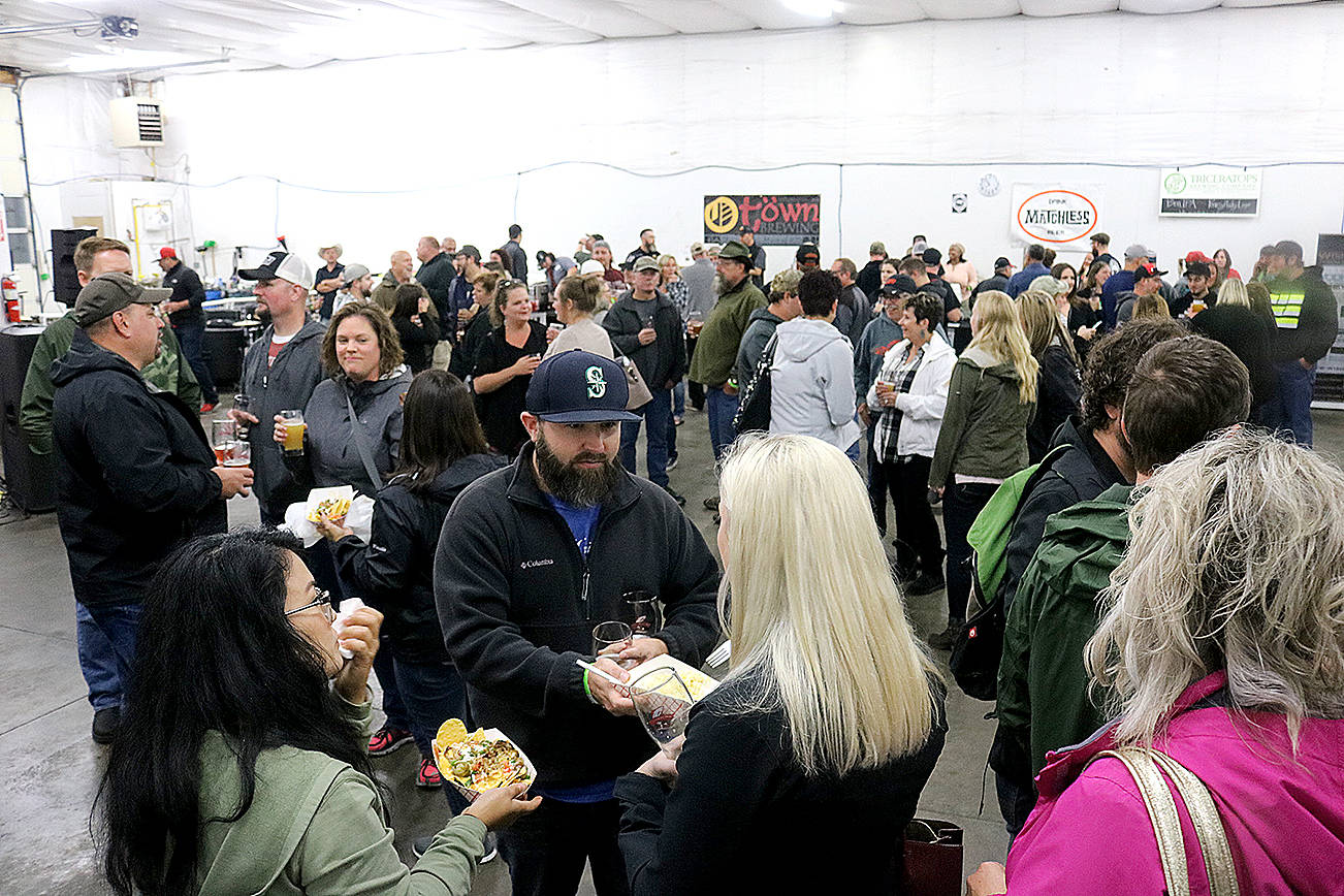 A large crowd gathers at 2017’s Catch Montesano Fish and Brew Fest in Fleet Park and Whitney’s detail shop in Montesano. Photo by Travis Rains, The Vidette file